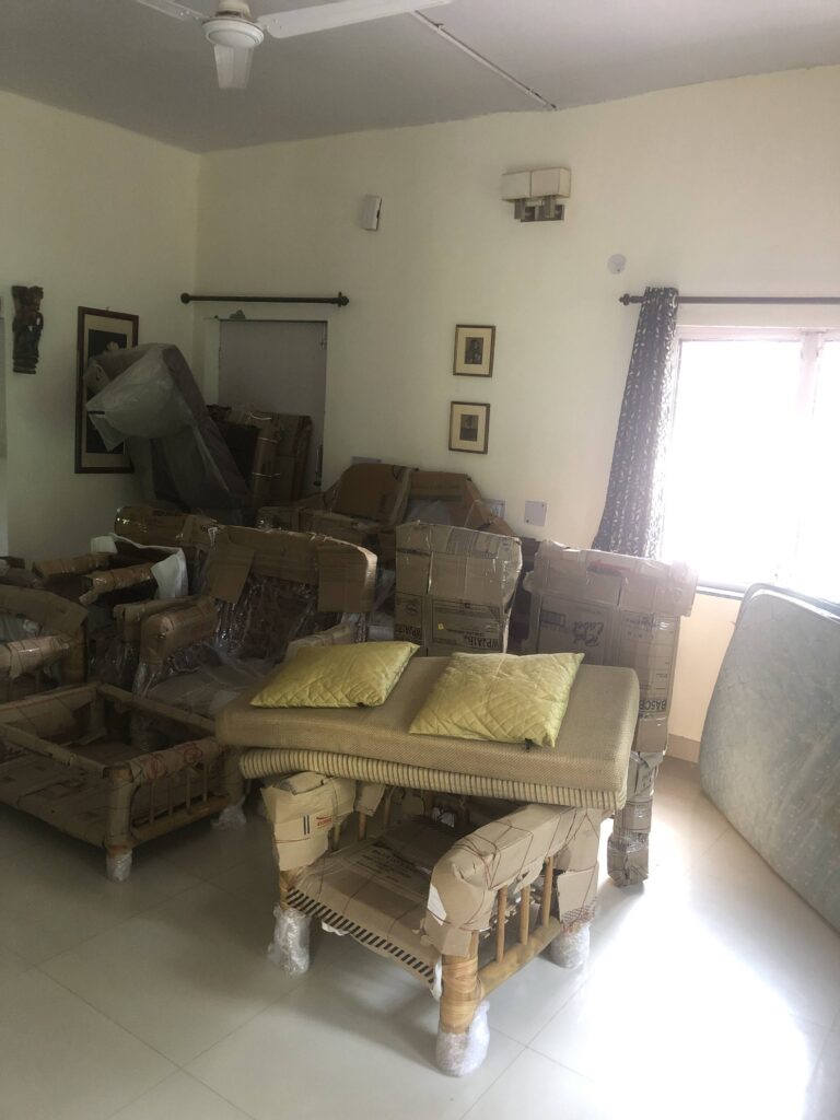 Army child moving homes with packed suitcases and trunks, symbolizing adaptability and constant change.